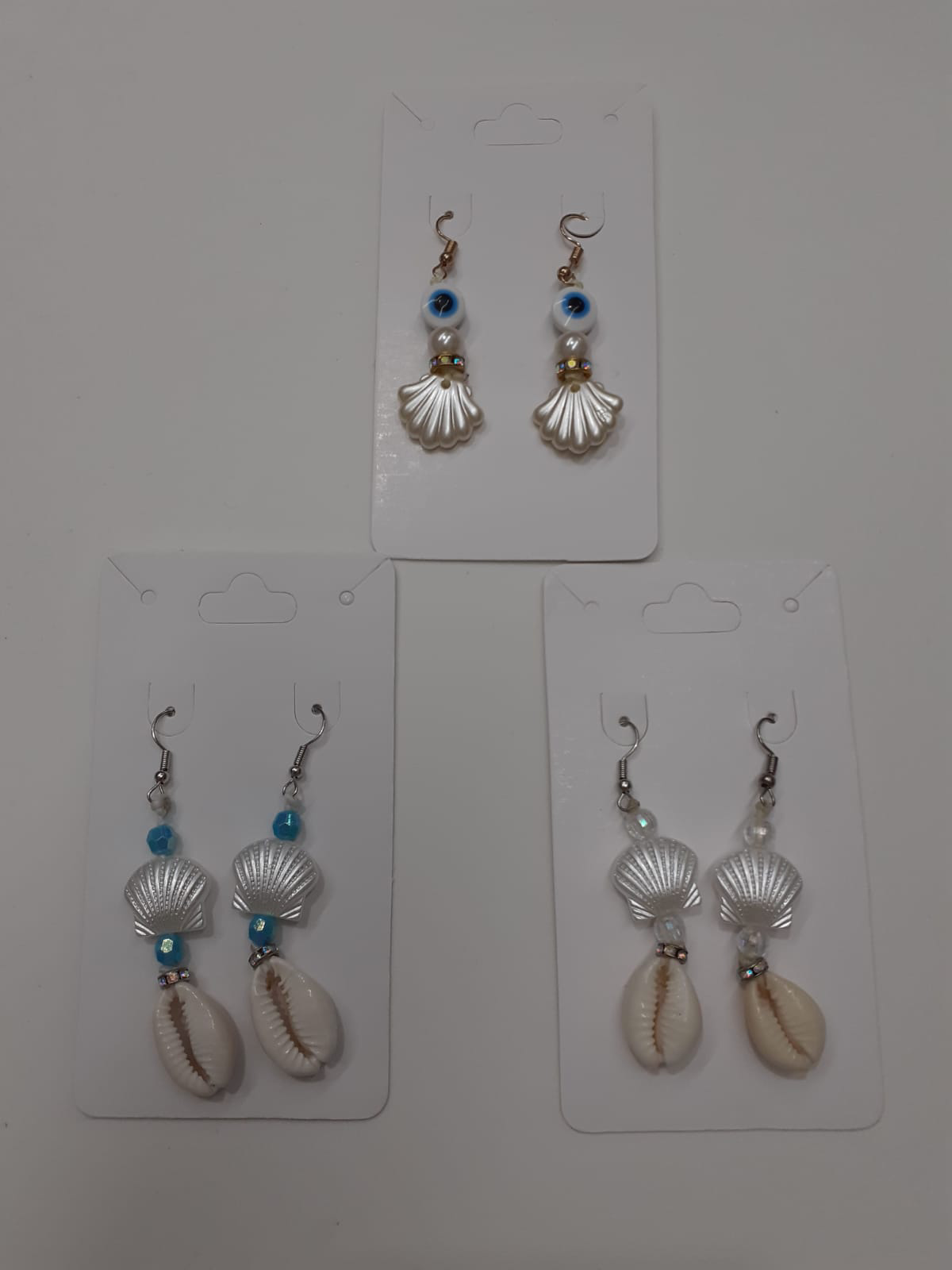 Brinco de Concha com Buzio e Olho Grego